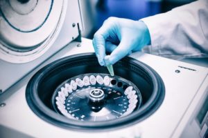 Close up of a chemist using a centrifuge