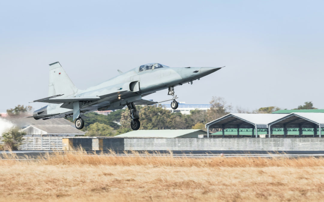 Fighter jet military aircraft flying with landing gear extended