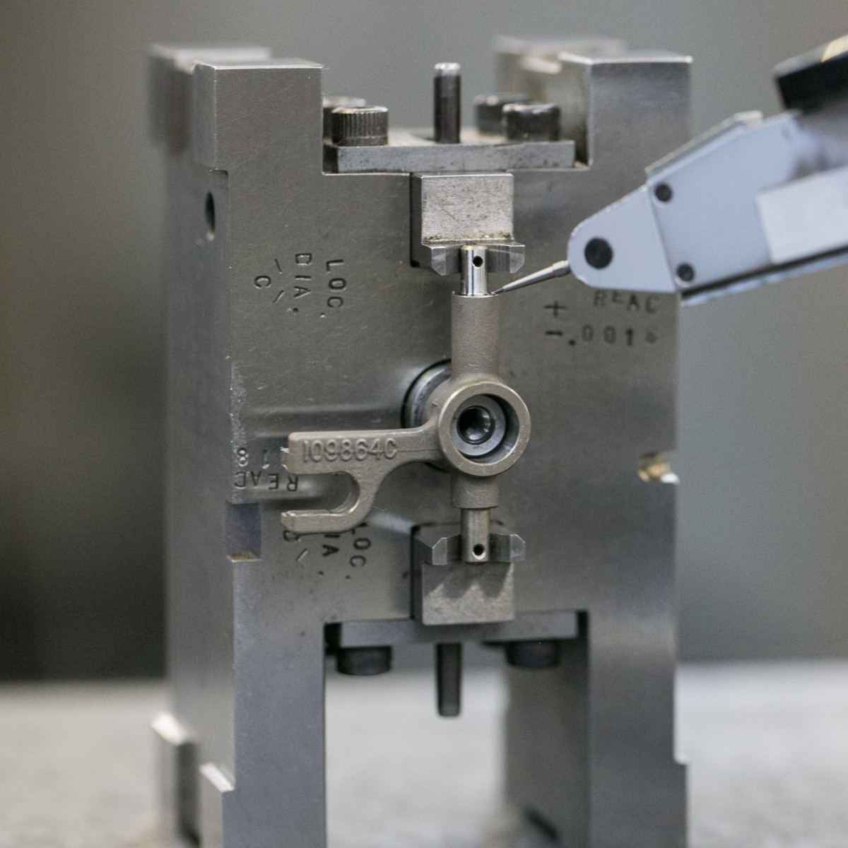 Closeup detail of an aerospace component fixtured for CMM inspection after precision grinding services.